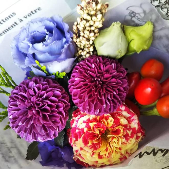紫色と青色の花と黄色に赤色をした花の花飾りの写真
